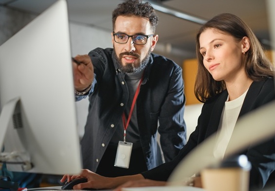 social engineering - two colleagues in front of computer