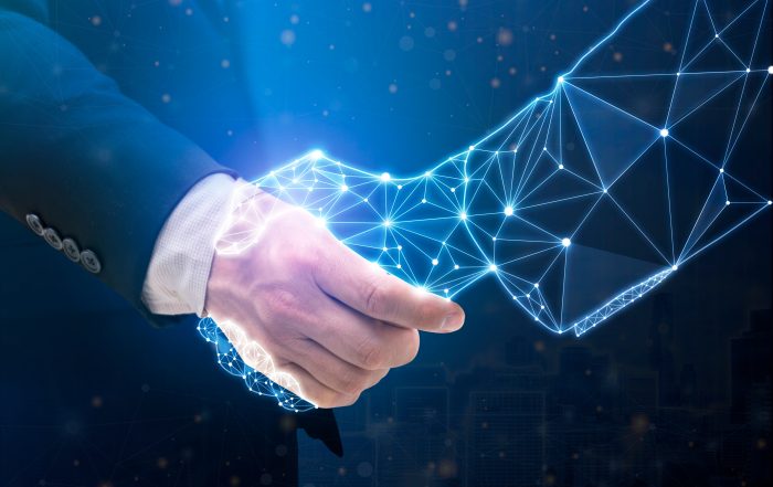 A human hand shaking a digital, glowing network hand, symbolizing human-technology collaboration, AI partnerships, or business-tech integration.