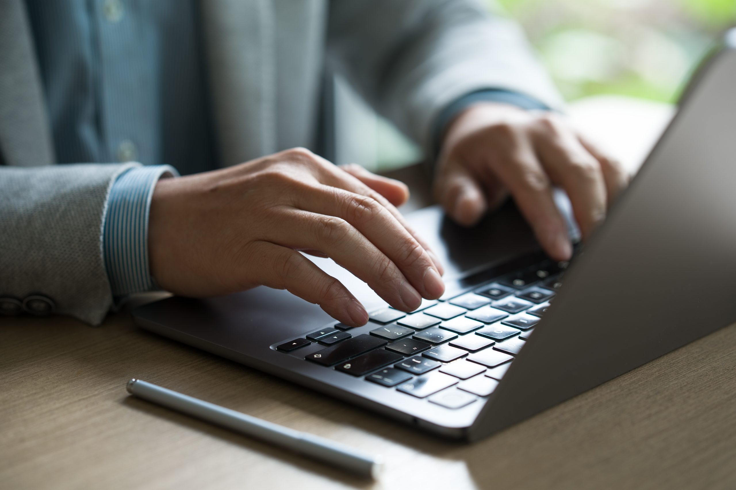 Professional Working on Laptop in Modern Office Environment How Automation Can Free Up Your Time