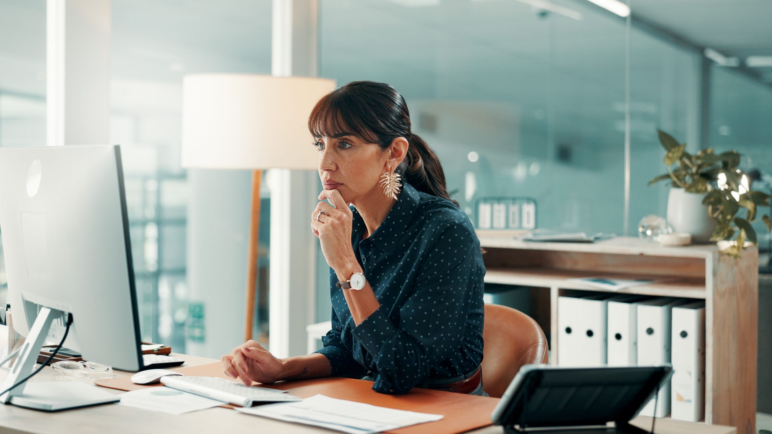Professional working at a desktop computer in a modern office How Smart Platforms Help Track Progress Automatically